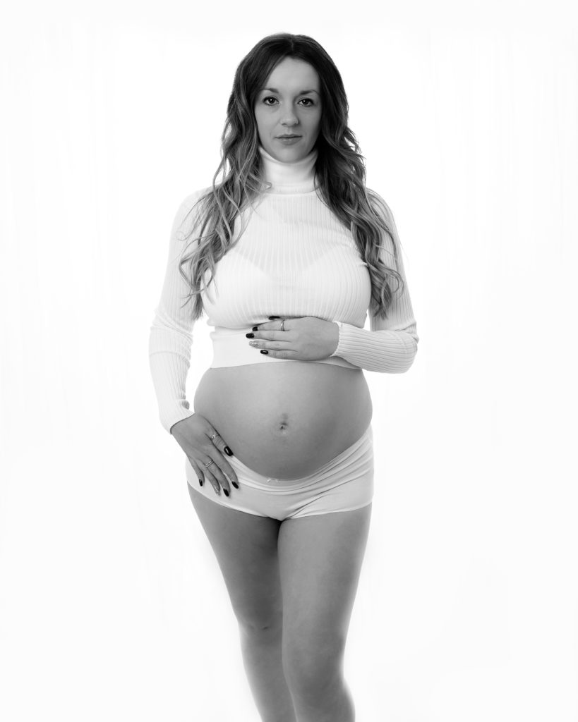 pregnant mum in white top by maternity photographer in Kent