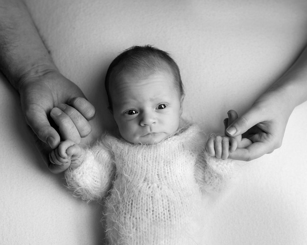 parents holding hands of newborn baby by Sandwich and Folkestone Newborn photographer