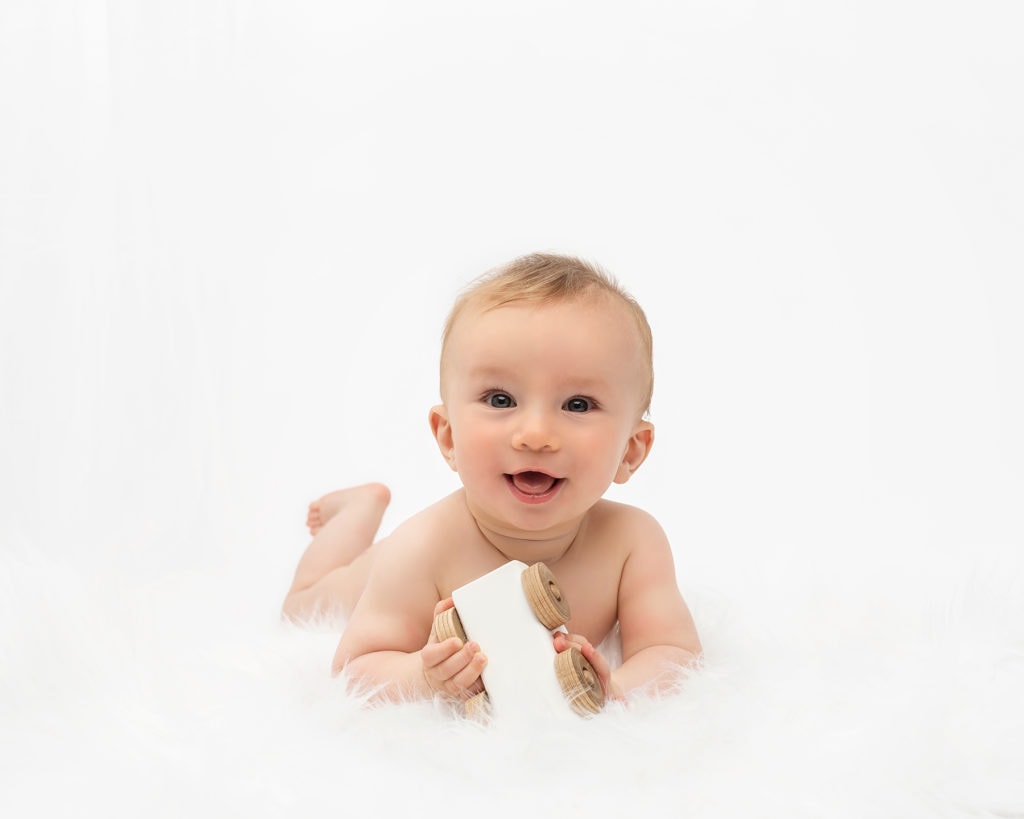 Baby laying on a fluffy rug on a baby photoshoot Canterbury Baby Photographer