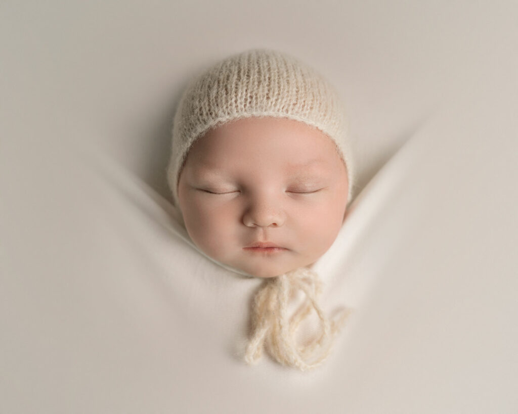 Baby Boy in cream bonnet on a photoshoot in Kent