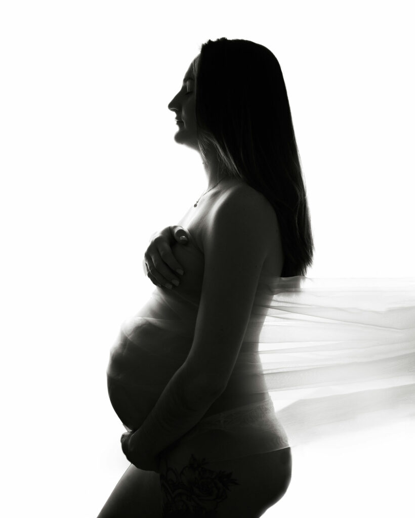 Black and white picture of a pregnant woman on. a photoshoot in Kent