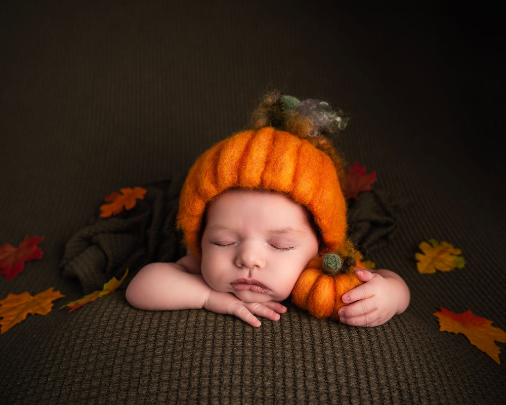 Sleeping Newborn baby in a cream bonnet on a baby photoshoot in Canterbury Kent